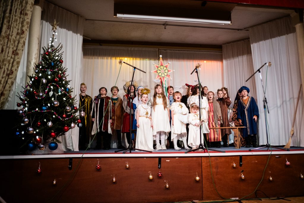 Ukrainian families come together to perform 'vertep' (nativity) on stage at Newcastle Congregational Church. They are dressed in a variety of costumes representing characters in the nativity including angels, shepherds and wise men. Credit Jenny Harper