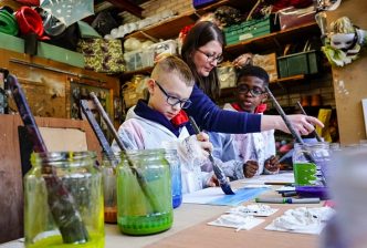 Props and Settings Maker Melissa McCann with young people taking part in the RSC Next Generation Project