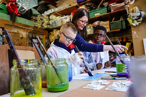 Props and Settings Maker Melissa McCann with young people taking part in the RSC Next Generation Project