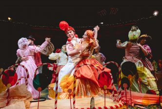 'Bonbonvillers' dance in pairs surrounded by giant candy canes and lollipops. Production picture from The Nutcracker at the New Vic. Credit Andrew Billington.