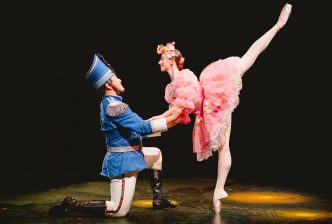 The Nutcracker, on one knee, holds the Sugar Plum Fairy as she performs a one-legged ballet pose on pointe. Production picture from The Nutcracker at the New Vic. Credit Andrew Billington.