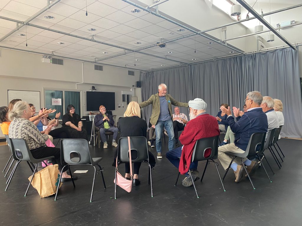 Told by an Idiot help the Dementia and Creativity Group brush up on their drama skills. The group sit in a circle around other participants performing in the middle. 