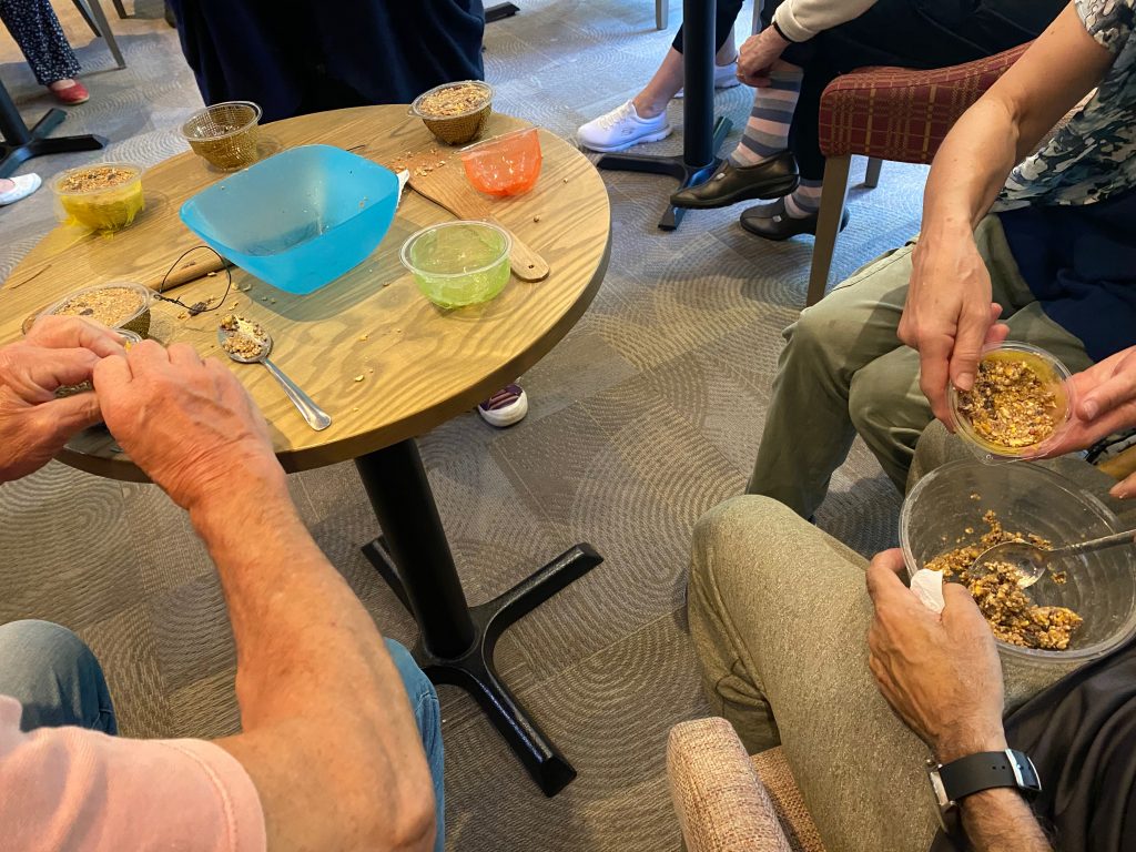 Mixing the ingredients together to make bird feeders.