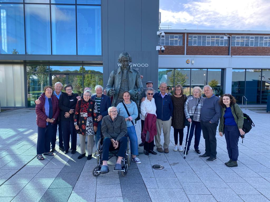 The Dementia and Creativity Group pose for a photo outside World of Wedgwood with the Josiah Wedgwood statue.