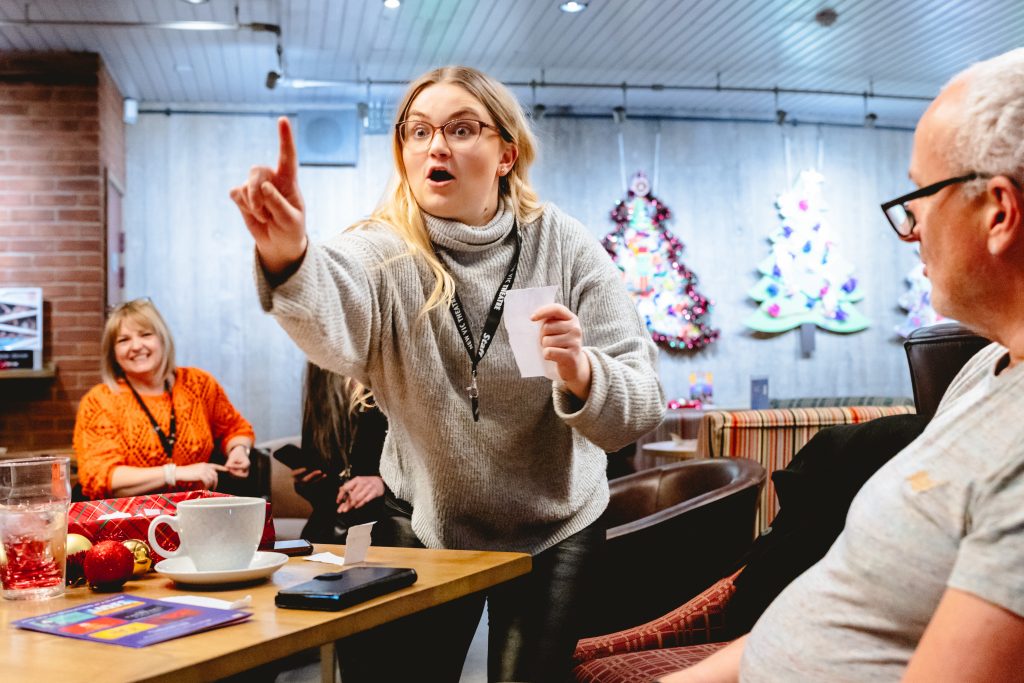 A girl points expressively as she acts out a charade. Picture from Next Chapter Christmas quiz night in the New Vic bar. Credit: Andrew Billington