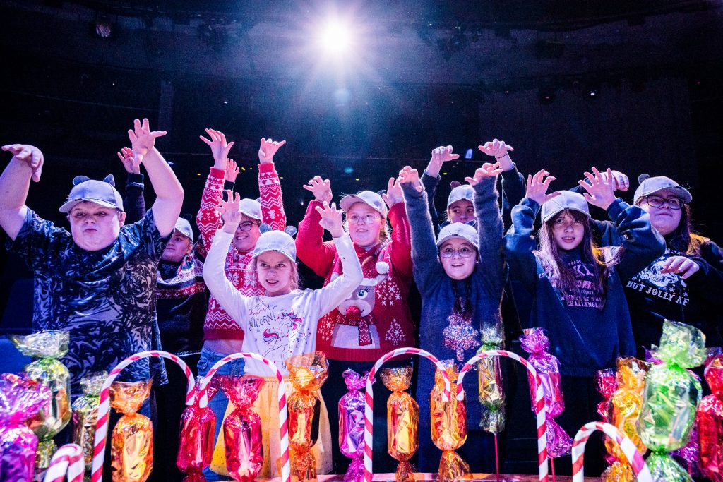 A group of young performers play menacing looking mice, surrounded by sweets. Picture from the Borderlines Young People's Theatre Company's version of The Nutcracker 2023. Credit: Andrew Billington