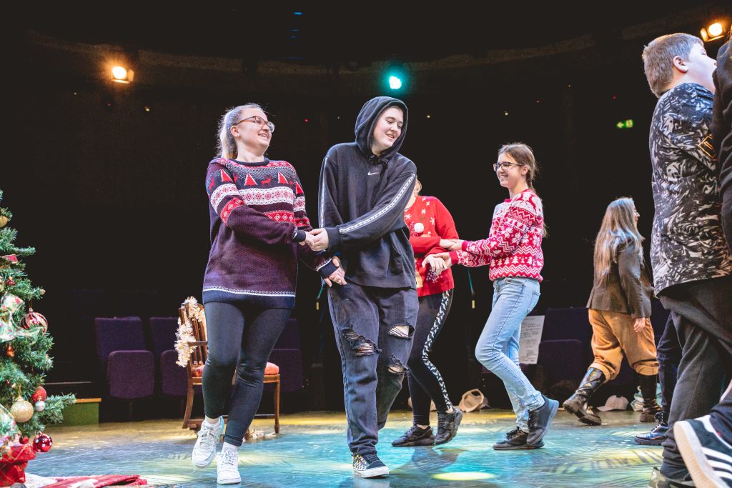 Young people dance in celebration. Picture from the Borderlines Young People's Theatre Company's version of The Nutcracker 2023. Credit: Andrew Billington