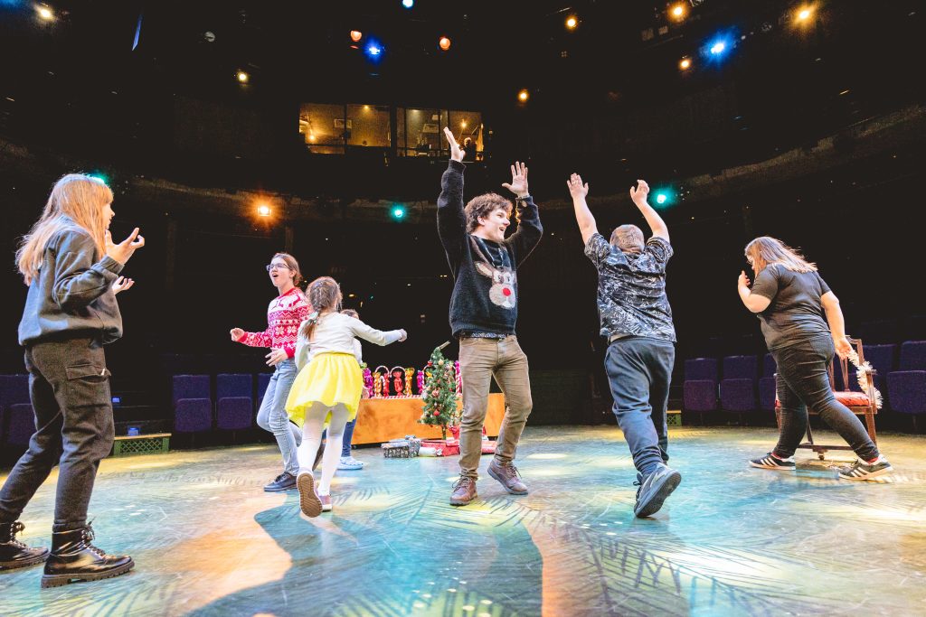 Young people dance in celebration. Picture from the Borderlines Young People's Theatre Company's version of The Nutcracker 2023. Credit: Andrew Billington