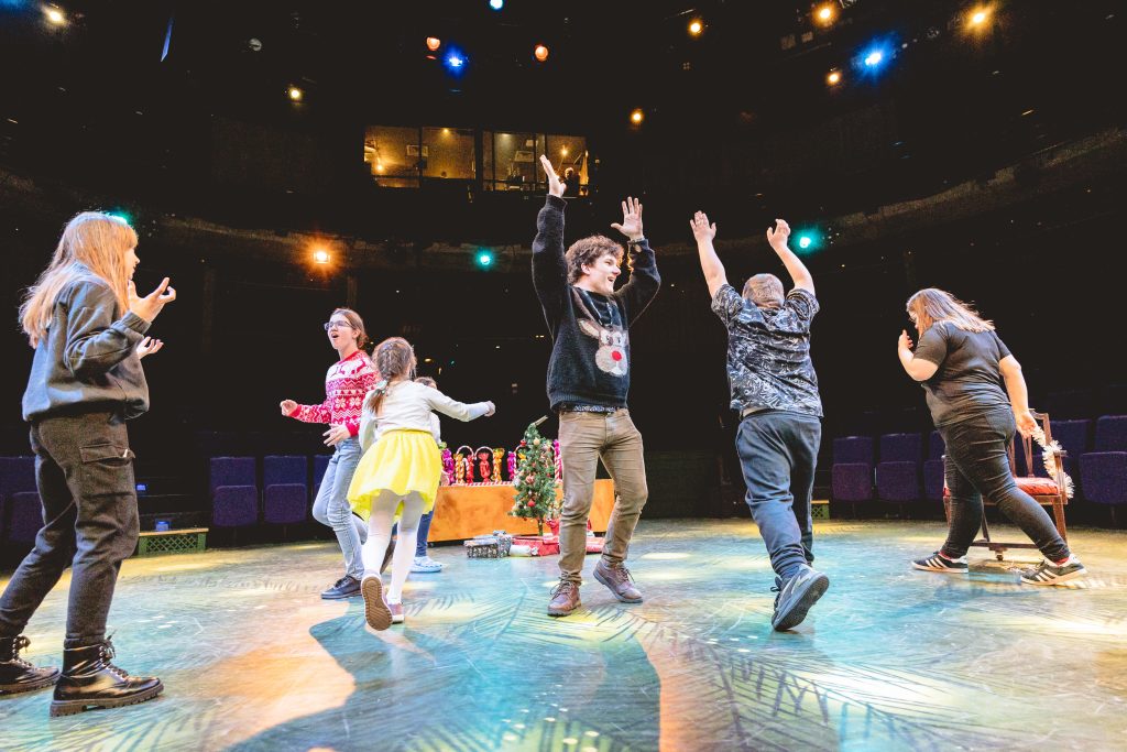 Young people dance in celebration. Picture from the Borderlines Young People's Theatre Company's version of The Nutcracker 2023. Credit: Andrew Billington