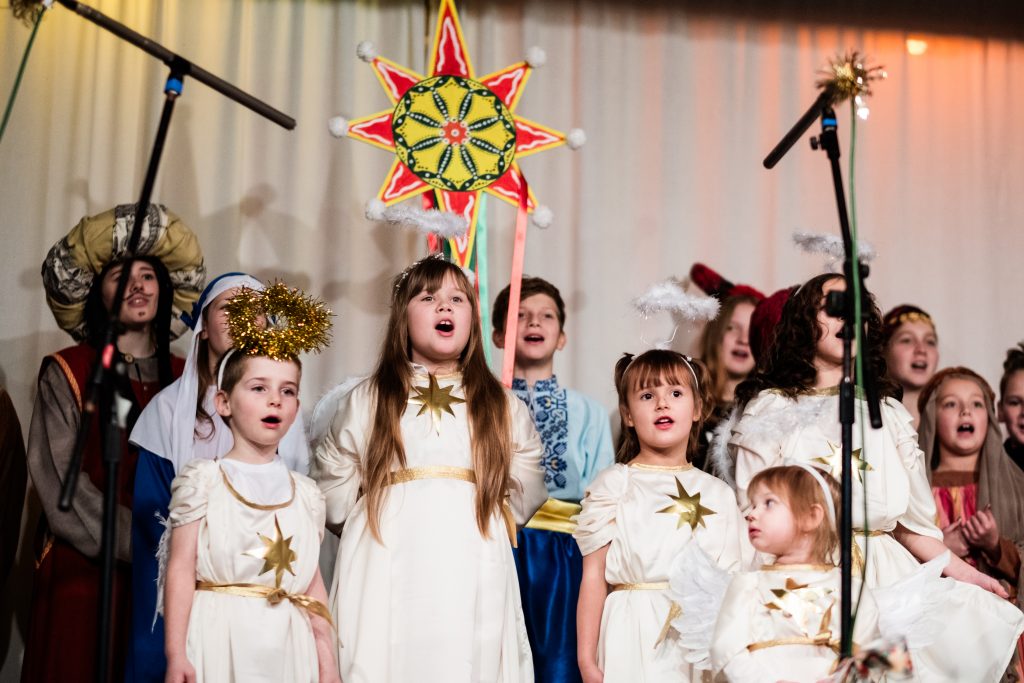 The chorus including angels and stars sing out during a scene in the nativity. Picture from the Vertep at Newcastle Congregational Church, performed by Ukrainian families. Credit: Jenny Harper. 