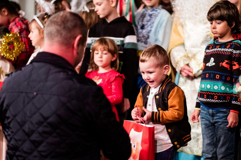 Presents are given at the end of the performance to excited looking children. Wide shot of the whole nativity scene. Picture from the Vertep at Newcastle Congregational Church, performed by Ukrainian families. Credit: Jenny Harper. 