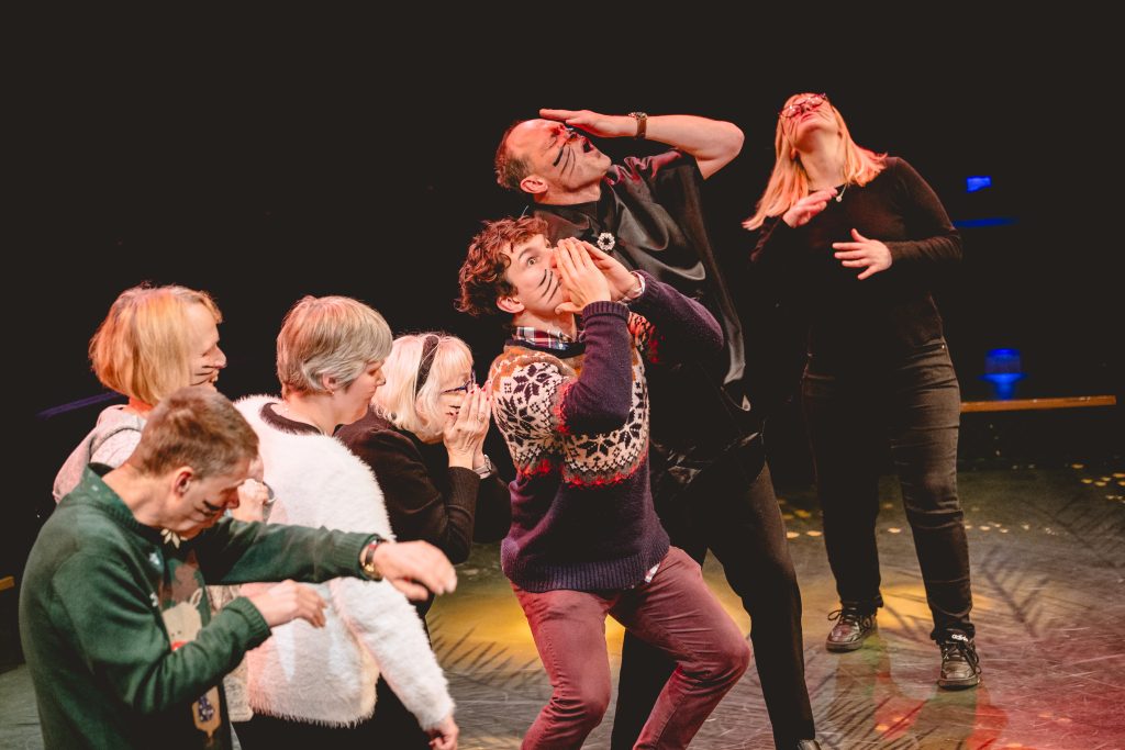 A group of people look into the sky in shock. Picture from the Strathcross version of The Nutcracker 2023. Credit: Andrew Billington