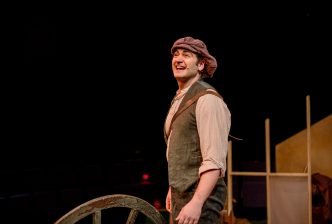 Moshe from 'Yizkor' looks at the audience, he is wearing period Eastern European World War 2 dress. Credit: Andrew Billington