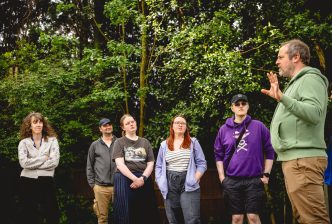 The Next Chapter group stand in the woodland space at the New Vic listening to the practitioner leading a drama game. Credit Andrew Billington