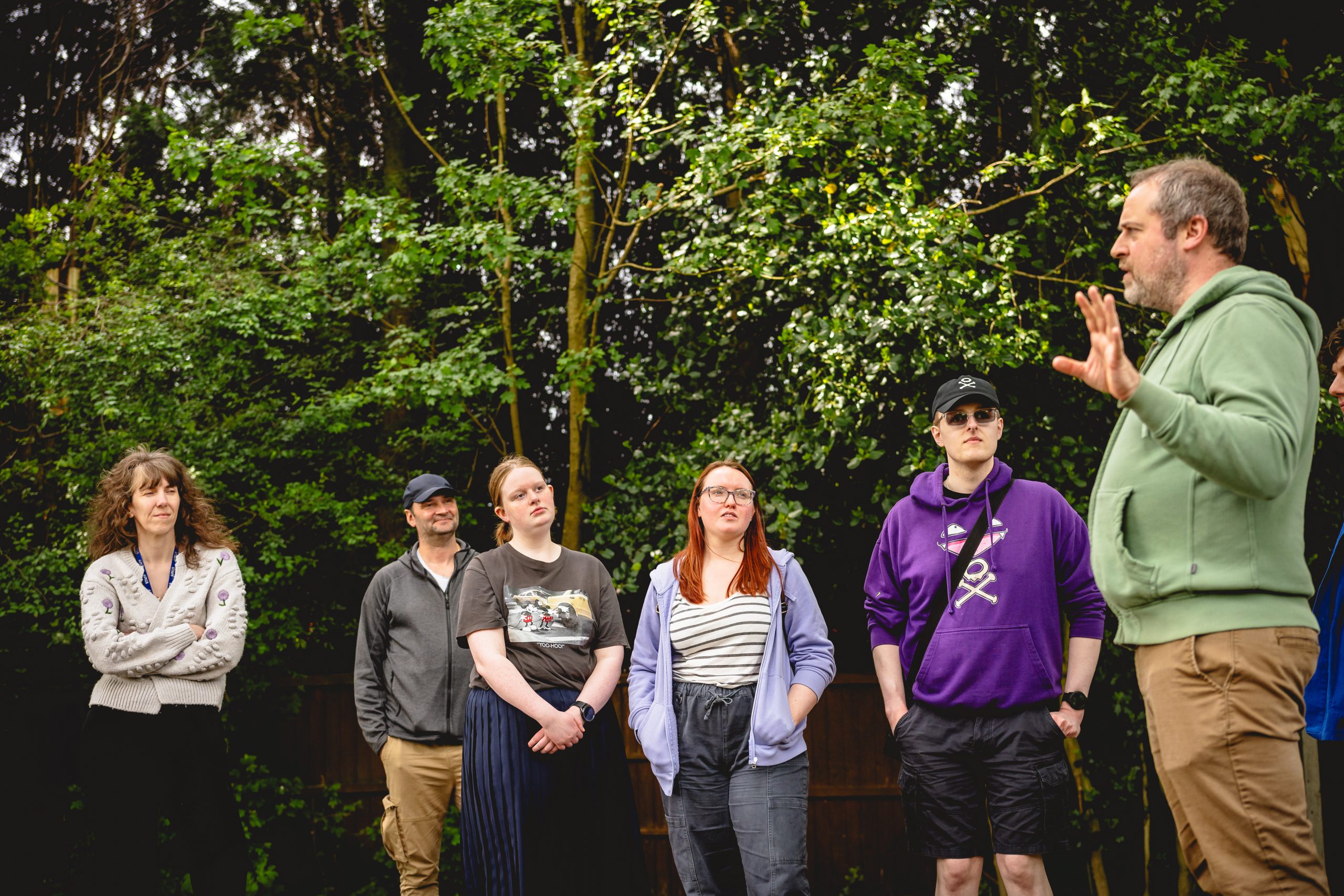 The Next Chapter group stand in the woodland space at the New Vic listening to the practitioner leading a drama game. Credit Andrew Billington
